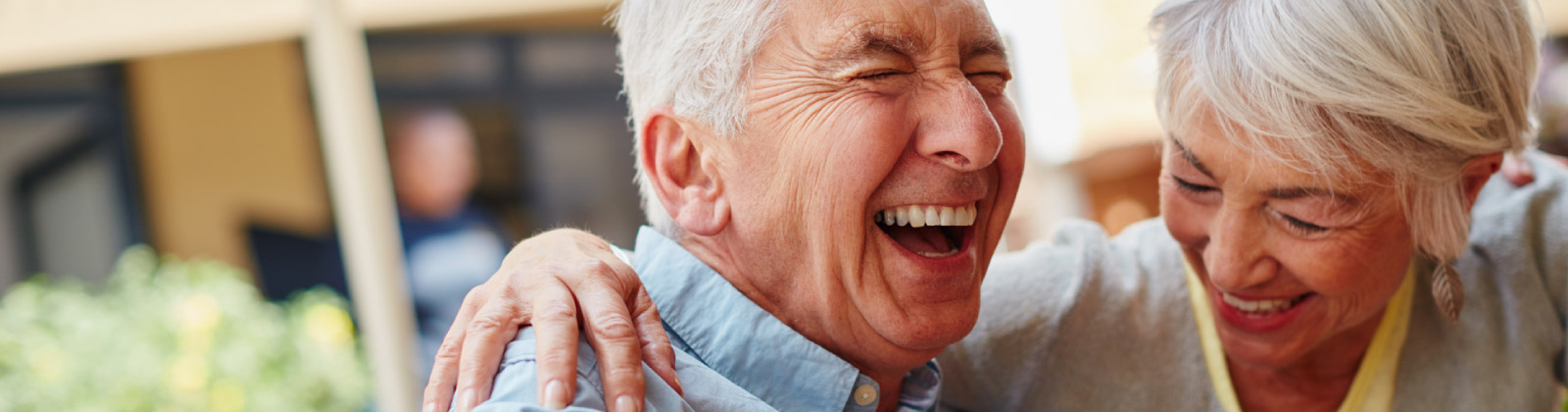 Older couple laughing together in joy. 