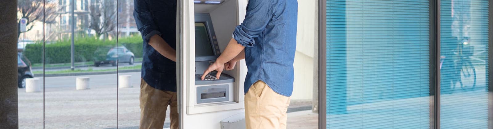 man using an ATM