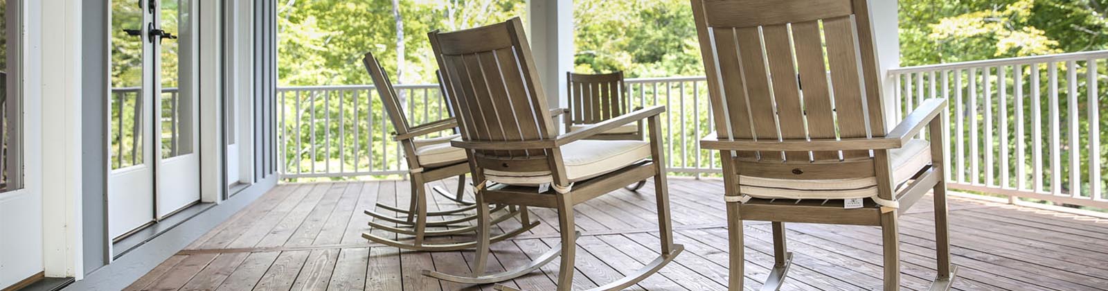 four rocking chairs on a front porch